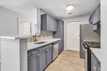 A kitchen with a white door and a sink.